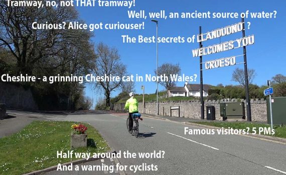 Cyclist passes the Welcome to Llandudno sign